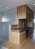 Modern home with Office, Desk, and Medium Hardwood Floor. The core in the middle of the apartment contains the staircase, two bathrooms, and a laundry area on the lower floor, and a small workspace upstairs. Photo 6 of Modern Dream Penthouse in New York City Makes the Most of Natural Light