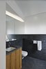 Modern home with Bath Room, Ceramic Tile Floor, One Piece Toilet, Undermount Sink, and Ceramic Tile Wall. The master bath is clad in Area tiles from Mirage. Photo 7 of Modern Dream Penthouse in New York City Makes the Most of Natural Light