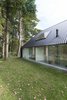 The house's "traditional" feel, Koolhaas says, is "only as thick as the layer of wood on the outside." When entering, the eyes travel straight back through the massive windows to the green yard beyond. "It appears as though there is no house behind the facade, like the houses on a movie set," he says. Photo 3 of Triangular House modern home