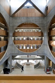 Louis Kahn opened up the interior of this brick library at Phillips Exeter Academy with a ceiling clerestory, which allowed sunlight to flow in and colorfully contrast with the stone-and-wood interior. Illumination was a focus down to the smallest detail, such as the teak study corrals positioned in light-filled spots.