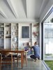“Working with the narrow qualities of the site, the internal spaces of the kitchen and main living areas can open completely to double them in size,” O’Neill said. The architecture firm built a custom bookshelf using drifted oak with the warm Ravine finish by Polytec. Photo 3 of Annie Street modern home