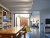 “The outlook from the kitchen and main house entry is directly into the two northern facing courtyards,” O’Neill said. A refrigerator by Fisher & Paykel stands in the kitchen next to a QASAIR Heritage range hood. Photo 7 of Annie Street modern home