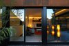 The second floor deck leads into an inviting living room. Throughout the home, green features are employed to achieve near-Passivhaus energy standards. Triple glazed Kneer-Südfenster windows are strong insulators, and polished concrete floors absorb and retain solar energy. Photo 5 of Ferrum House modern home