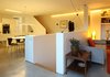 The Piet Hein Superellipse dining table adjacent to the kitchen is homeowner Andrew Pennock's favorite part of the house. He enjoys watching the changing light while drinking coffee, eating meals, and using the space as a home office. Having the main living area elevated on the second floor is "a delight," says Pennock. It "takes you away from street level and offers a slightly different perspective on the world." Photo 7 of Ferrum House modern home