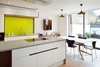 Fraher’s in-house joinery company designed the kitchen cabinets. The majority of the furniture — including the dining table and chairs — is Ligne Roset. Photo 4 of Lantern Home modern home