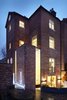 At night, the house’s unique windows glow brightly, much like a lantern. Photo 9 of Lantern Home modern home
