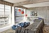 Modern home with Living Room, Chair, Sofa, Rug Floor, and Concrete Floor. The 1,200-square-foot apartment suite comes with a cozy bohemian couch by Busnelli and an orange-hued hanging light and futuristic, blue Bianco table by Knibb Design.
Every room at the Line hotel offers floor-to-ceiling windows that appear to frame views of the city, including the surrounding 1960s modernist skyscrapers, and in some cases the distant cityscape and Hollywood sign. Concrete is the main design element of the hotel, and it adds an authentically urban ambiance to each of the 388 rooms, which also showcase large-print photographs from LA-based artist Kevin Hanley and furnishings designed by Sean Knibb. Photo of Modernist Building in Los Angeles' Koreatown is Redesigned as The Line Hotel