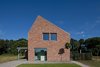 The bricks were locally sourced from the surrounding Brabant region. While gabled structures such as this are a common sight, the Riel Estate's lopsided roof sets it apart. Photo of A Dutch Home that Plays with Traditional Brick Architecture modern home