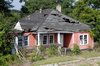 An derelict abandon house once sat on the plot of land. Here's what it looked like before. With the help of locals, artist Matthew Mazzotta demolished the house, saving materials where he could. Once everything that could be salvaged was set aside, the fire department burned the remainder. Photo of Watch an Unassuming House Unfold into a Community Theater modern home