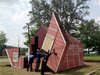 The house unhinges and it becomes seating for 100 people. Day to day, the lot is a community park. Photo of Watch an Unassuming House Unfold into a Community Theater modern home