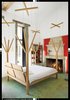 All of the beds in the house are playful custom one-off designs by Crasset, including the marionette-themed master bed, which a local carpenter fabricated from oak felled in the surrounding forest. The stone fireplace is original. Photo of Unusual Sleeping Spaces modern home