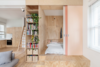 The new floor plan maximizes social areas and minimizes sleeping spaces through the creation of “micro” bedrooms that fit a single bed. The rooms were sectioned off with full-height, pine plywood joinery — a nod to Shigeru Ban’s Furniture House. Sliding doors reminiscent of Japanese Shoji screens can be drawn closed for intimacy or opened to extend the visual space. Photo of A Tiny Apartment Renovation for a Growing Family in Melbourne modern home