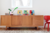Keeping the white walls mostly bare also helped the apartment feel less cramped. Instead, a vintage Danish credenza offers a contained space on which to display small framed art works and other unique objects. Photo of A Tiny Apartment Renovation for a Growing Family in Melbourne modern home