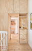 The full-height cabinets offer plenty of nooks and crannies where household goods can be hidden away. “Carefully considered storage provides space for each family member’s essentials, yet limits consumption and places greater value on the objects that they have chosen to live with,” Cousins says. Photo of A Tiny Apartment Renovation for a Growing Family in Melbourne modern home