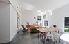 Modern home with Dining Room, Table, and Chair. For the the living room, the architects designed a cluster of picture windows that frame unique views—a jacaranda tree or a patch of sky—and block out neighbors from a nearby apartment building. Photo of A Traditional 1920s Bungalow with a Boxy Modern Extension