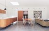 Modern home with Dining Room, Table, and Chair. The clients had an impressive collection of Scandinavian midcentury teak furniture that now pops beautifully against the concrete floors, white-painted brick, and pine v-joint walls. Photo of A Traditional 1920s Bungalow with a Boxy Modern Extension
