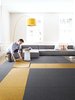 "Unlike traditional broadloom and area rugs, we’re a modular system that allows you to create custom rugs, runners, and wall-to-wall designs to fit any size and shape," senior designer Cristina Englund says. "With broadloom rugs, you have to replace whole sections of a rug at a time, but with FLOR you can pick up one square and clean it in the sink." Photo of Ditch the Area Rug: This Easy, Modular Carpet System Has Serious Green Cred modern home