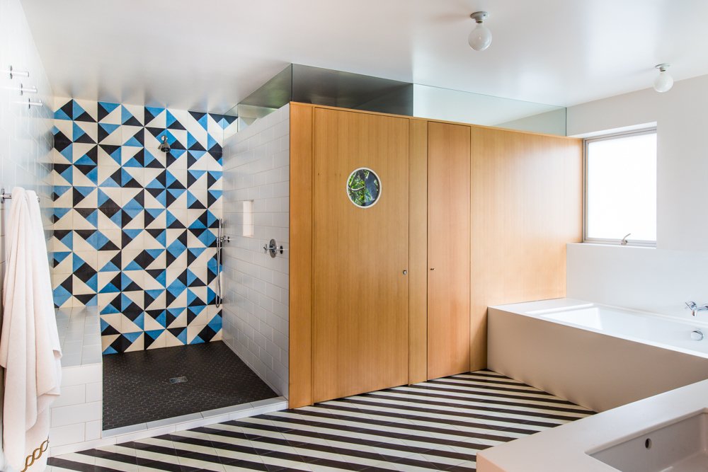 The tub surround is also Corian; the shower floor is Charcoal Grey porcelain from American Universal Corp.