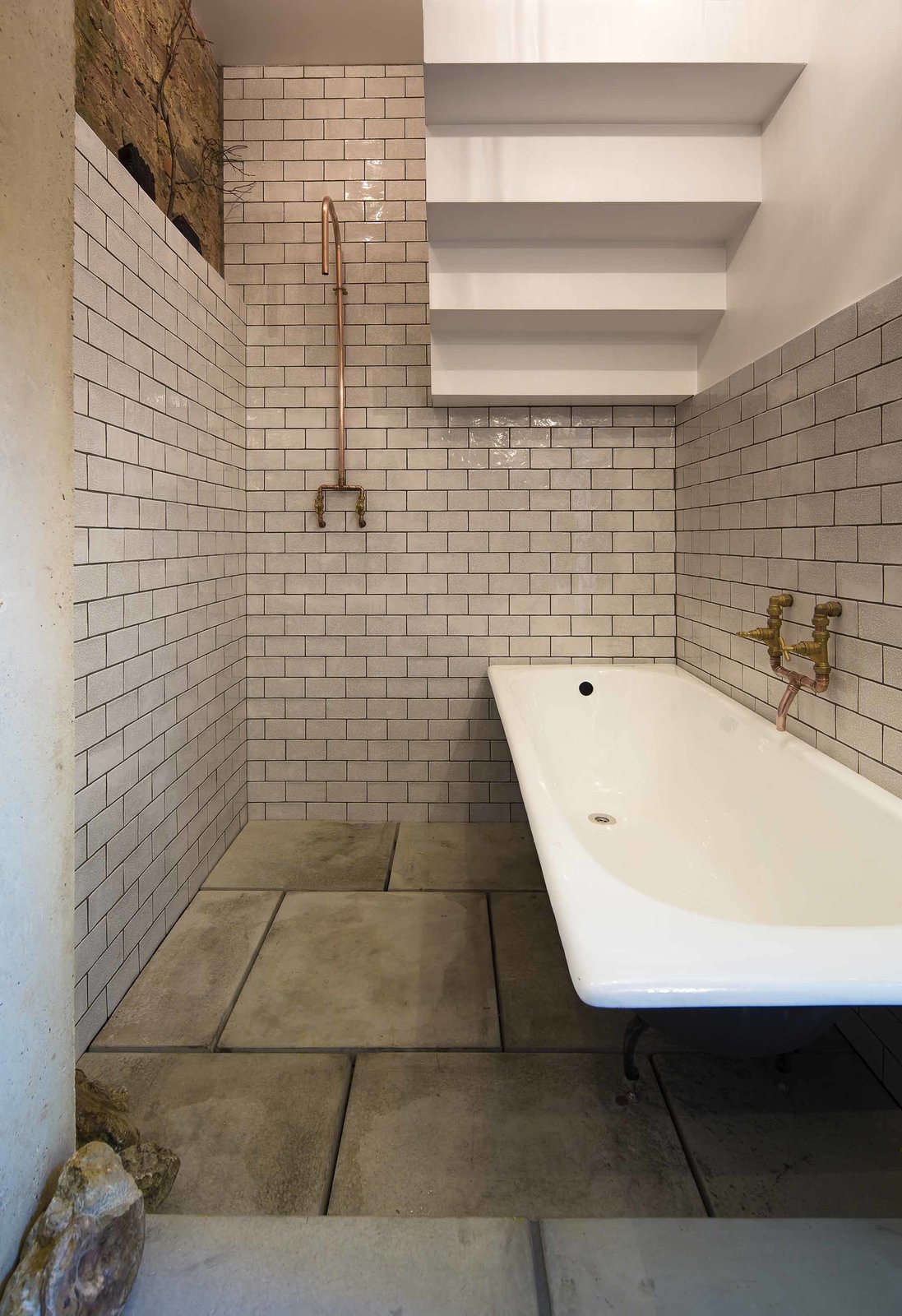 In the bathroom beneath the stairs, copper fixtures and subway tile feel at once sensitive to the home's roots and very of the moment. It is this attention to cohesiveness that the Don't Move Improve! award seeks to recognize.