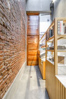 The space is also adorned with timber cladding, as seen on the entry door.