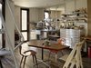 Modern home with Kitchen and Metal Counter. Outfitted with shelves by EZ Shelving and a generic tool chest, the kitchen’s galvanized steel integrated counter and sink was designed by Baker and fabricated by DeFauw Design + Fabrication. A vintage pair of Norman Cherner’s Plycraft chairs and an A Chair by sustainable furniture-maker David Colwell surround a table by Pacassa Studios, which mounted a custom top on a Herman Miller Eames base. All appliances are electric, including heat-radiating panels, a combo washer-dryer unit, and an induction stove. Photo of This Net-Zero Residence Might Be the Greenest Home in San Francisco