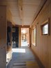 Eastern white pine finished with Monocoat white oil by Rubio clads the interior, while slatted wood accents the space and screens pipes and ducts. Photo of An Eco-Friendly New Hampshire Home Stands Out for its Simplicity modern home