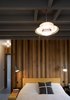 Thomson notes that the uniformity in the property is a nod to minimalism, but there are small details that distinguish one room from another. The size of the flooring tiles, which are heated, change in size from the front of the home to the back in order to create a “varied rhythm,” he says. The timber ceiling is painted with Farrow & Ball’s Charleston Grey. Photo 6 of Islington Residence modern home