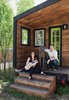 Modern home with Exterior, Tiny Home Building Type, and Wood Siding Material. Boise, Idaho–based architectural designer Macy Miller built her own 196-square-foot home, which she shares with her partner, James Herndon, their newborn, Hazel, and the family’s Great Dane, Denver. The exterior cladding, which Miller stained for a uniform effect, is a mix of nearly a dozen types of wood plank, including poplar, oak, and fir. Photo of Inside 5 Tiny Homes, All Under 600 Feet