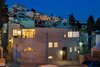 The historic facade blends in with the new stone of the addition. Several balconies on the upper level encourage outdoor living, and enable movement between the two private wings of the home. Situated on a hill in the old historic district, sweeping views are enjoyed from these private outdoor retreats. Photo of A 250-Year-Old Stone House in Israel with a Surprisingly Modern Interior modern home