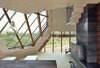 Each room in the interior was carefully curated to reflect the unique function of that space. The interior interacts intimately with the surrounding landscape, as different visual perspectives of the dunes are framed by the geometric facade. Photo 4 of Dune House modern home