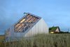 Illuminated at dusk, the home brings light and energy to the sleepy dunes. Relying on cues from the natural beauty of the surrounding landscape, the home quietly but confidently makes its presence felt. Photo 8 of Dune House modern home