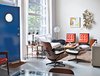 Modern home with Living Room, Recliner, Sofa, Concrete Floor, and Chair. The couple supplemented the rawness of the open living area with funky secondhand finds from the 1960s, ’70s, and ’80s. Photo of Raw Materials Connect this Chicago Renovation with its Industrial Past