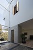 Thirty vertical feet of glass constantly face the stairwell, providing framed views of the sky, trees, and backyard. Materia Arquitectónica co-founder Gustavo Carmona describes it as an “interior façade” that blurs the barrier between interior and exterior. Photo of A Daring Hillside Home Made of Wood, Concrete, and Volcanic Stone modern home