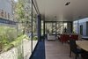 Modern home with Living Room and Sofa. Ample floor-to-ceiling windows mean residents rarely have to turn on lights during the day. The living room flooring, seen here, also features oak but in warmer tones. Photo of A Daring Hillside Home Made of Wood, Concrete, and Volcanic Stone