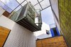 A rich pine exterior complements the brick, which was painted white as a means to minimize the use of cement. Photo of Amazing Examples of Shipping Container Architecture modern home