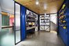 The hobby room features a custom desk and shelving system that Atelier Riri designed and manufactured themselves. A custom frame holds the family’s tools and other objects on the eastern wall. Photo of 20 Ideas On What You Can Do With Old Shipping Containers modern home