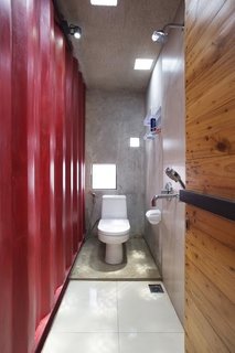 In one of the home’s three bathrooms, a TOTO toilet is illuminated by LED light fixtures from OSRAM. Simple square-shaped skylights and windows allow natural light to fill the space.