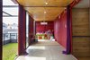 Modern home with Kids Room, Playroom Room Type, Storage, Concrete Floor, Toddler Age, Neutral Gender, and Pre-Teen Age. A cherry red game room gives way to a second green space on the roof, which can be used as an extension of the indoor space. Photo of 20 Ideas On What You Can Do With Old Shipping Containers