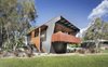 Modern home with Outdoor, Back Yard, and Grass. The architects’ inventive use of resources helped keep costs down. “We gave the facade’s ribbed metal cladding, commonly used in neighboring beach shacks, a metallic finish that provided a cost-effective solution and an upscale appearance,” Rathmayr says. Photo 2 of Northern Rivers Beach House