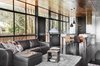 Modern home with Living Room, Sectional, Sofa, Pendant Lighting, and Dark Hardwood Floor. An open-plan kitchen, living, and dining area runs along one side of the upper floor. A study is situated next to the kitchen, while the other half of the building houses the two bedrooms. Black matte bamboo flooring by Silestone and birch ceilings, finished in a walnut stain, add warmth and texture to the interior. Photo 4 of Northern Rivers Beach House