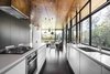 Modern home with Kitchen, White Cabinet, Pendant Lighting, Range, and Undermount Sink. In the kitchen, a Blanco exhaust fan is surrounded by a stove, oven, and dishwasher by Westinghouse. A series of pendants by She Lights are equipped with LED fittings. Photo 5 of Northern Rivers Beach House