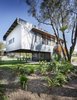 Modern home with Exterior, House, and Metal Siding Material. The largest portion of the living area is supported by cross-braced columns. Flanged steel beams create a strong, lightweight frame. Photo 7 of Northern Rivers Beach House