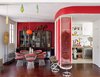 Modern home with Dining Room, Table, Chair, and Medium Hardwood Floor. A far cry from minimalism, the renovated 900-square-foot Paris flat belonging to Nicolas Roche, a scion of the French furniture company Roche Bobois, is decked out with vivid hues and vintage furniture. A 1960s orange lamp by Luxus is suspended over the Warren Platner dining table and chairs. The 1950s rosewood glass cabinet is from Soriano. Pod Lens pendants by Ross Lovegrove for Luceplan hang from the ceiling. Photo of Homes Filled with Colorful Furniture