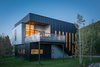 Modern home with Exterior, Metal Siding Material, House, and Flat RoofLine. Pared-down and rectangular, the 2,300-square-foot Cache Creek residence was built with a modest budget. “We set out to do a very big thing with a very small amount of money, and we achieved all our goals and more,” says architect Eric Logan. “It’s a wonderful little box.” Photo of A Fun, Cost-Conscious Home with Bright Interiors and a Climbing Wall