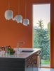 Modern home with Kitchen, Drop In Sink, and Pendant Lighting. A polished chrome faucet from Kohler’s Purist collection enhances the kitchen. Walls and ceilings are made of drywall and painted brilliant hues that complement the home's industrial exterior. Photo of A Fun, Cost-Conscious Home with Bright Interiors and a Climbing Wall