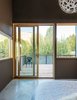 Modern home with Bedroom, Bed, Pendant Lighting, and Concrete Floor. A Coral Pendant by David Trubridge hangs in the master suite, which opens up to a large deck. Photo of A Fun, Cost-Conscious Home with Bright Interiors and a Climbing Wall