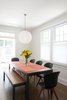 Sullivan, a contractor, owns the remodeling company Impact Construction. He designed and performed the work in several stages, with collaboration from friends Kevin Nigri, AIA, and Stephen Strasser. The dining table, the Parsons model from Room & Board with a walnut top, is surrounded by Adelaide chairs from BoConcept. The Random pendant light is by Moooi. Photo of A Smart Modern Remodel of a Traditional DC House modern home