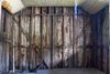 The master bedroom is seen during partial demolition. As part of a kit home, the original 19th-century framing was marked with Roman numerals to enable on-site assembly, and relocation/reassembly (if necessary) during shipping and construction in the 1850s. Photo 6 of 1850s Prefab Cottage from Boston Finds New Life in Australia modern home