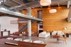Modern home with Living Room, Chair, Sofa, Ottomans, Coffee Tables, Console Tables, Floor Lighting, and Pendant Lighting. The downstairs offers an assortment of places and ways to entertain - the kitchen, two living room schema and a dining room table designed by Camilo Prada for Weston Wood Works. Photo of A Miami Renovation That Blends Concrete and Rich Wooden Interiors