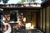 Before
When Schicketanz bought the 2,054-square-foot house for $650,000 in 2012, it was dark and dilapidated, sinking two inches out of plumb toward the creek. Unsightly fiberglass panels lined the front door walkway. Plus, there was a woodpecker problem. “The plywood on one side had a million holes in it,” she recalls. “When we opened the walls inside, I don’t know how many pounds of acorns poured out.” All in all, she spent about $270 per square foot to completely renovate the structure. Photo 2 of Torres House modern home